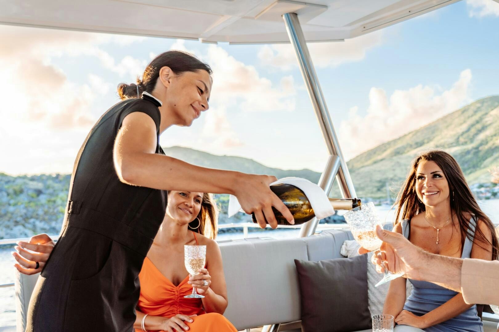 a man and woman sitting on a boat with a woman holding a glass aboard OCEANUS Yacht for Sale
