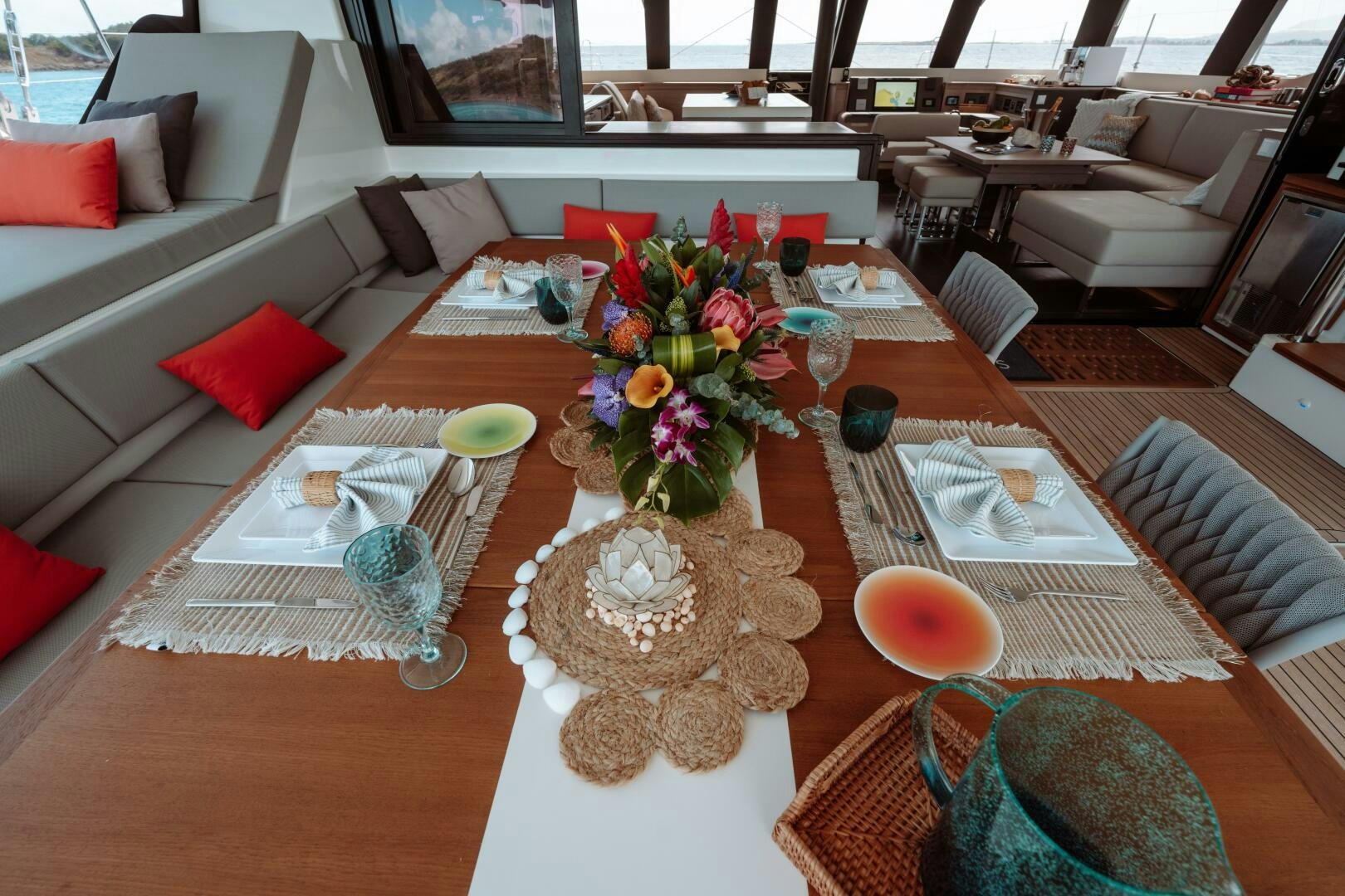 a table with a vase of flowers and candles on it aboard OCEANUS Yacht for Sale