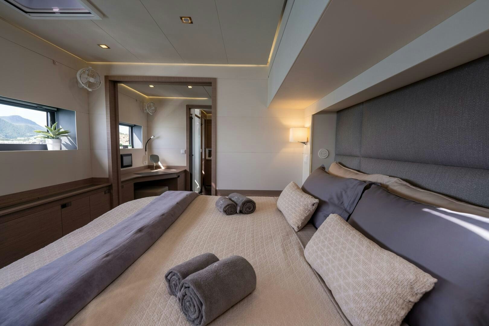 a bedroom with a bed and a couch aboard OCEANUS Yacht for Sale