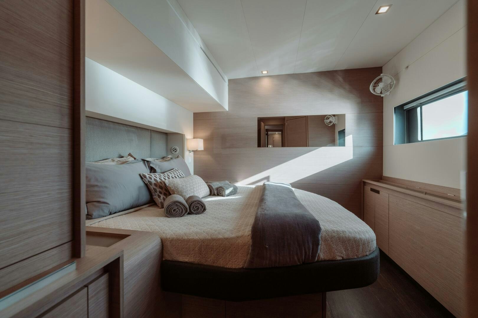 a bed with a mirror above it aboard OCEANUS Yacht for Sale