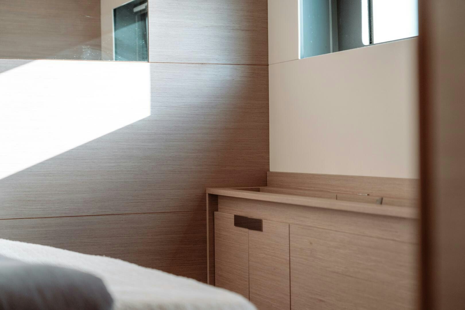 a wooden shelf with a white bed aboard OCEANUS Yacht for Sale