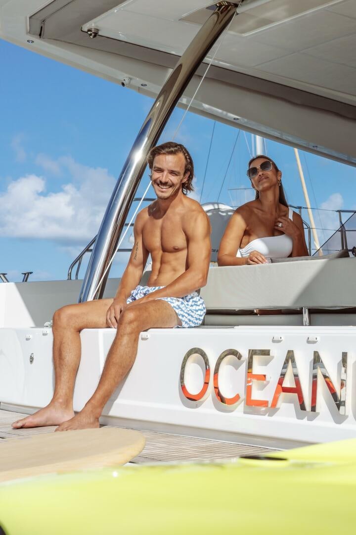 a couple of men sitting on a boat aboard OCEANUS Yacht for Sale