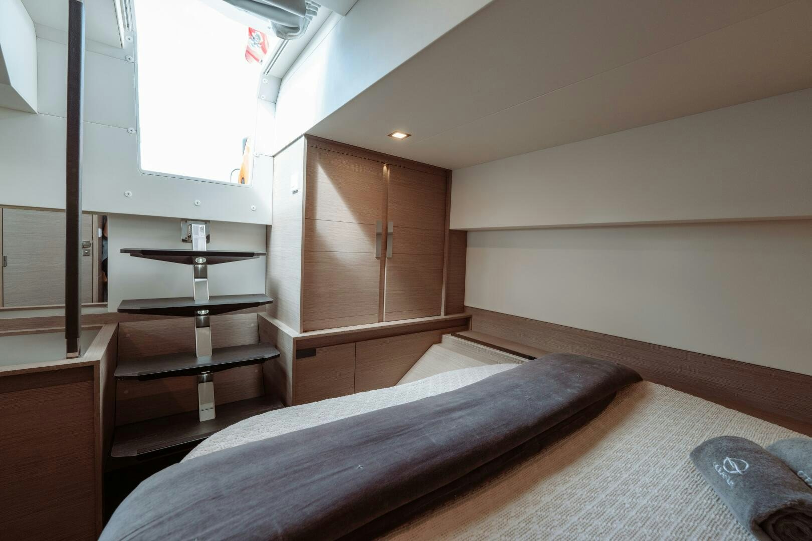 a bedroom with a bed and a shelf aboard OCEANUS Yacht for Sale