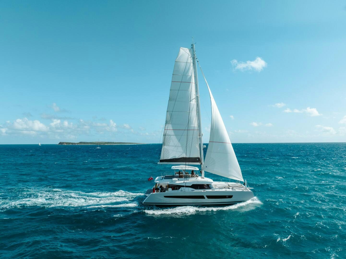 a sailboat on the water aboard OCEANUS Yacht for Sale