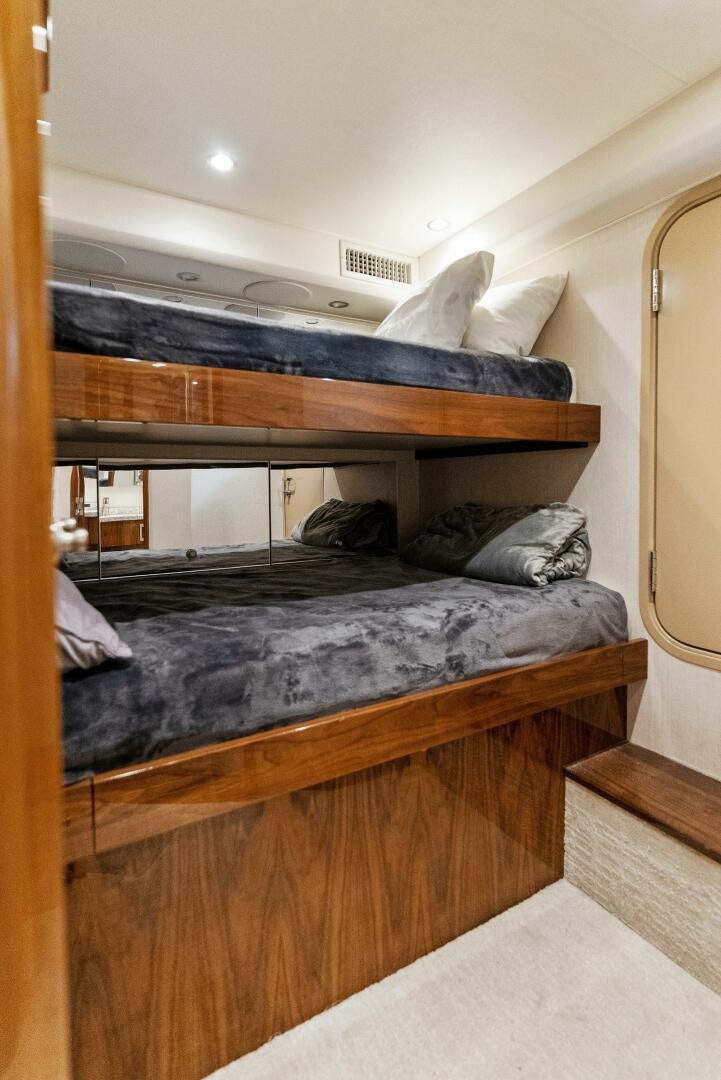 a bed with a black comforter aboard SEA HAWK Yacht for Sale