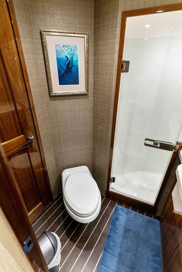 a bathroom with a toilet and a door aboard SEA HAWK Yacht for Sale