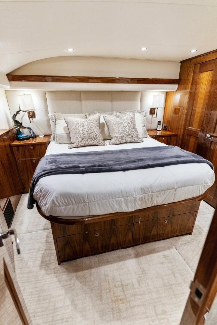 a bed with a black and white bed spread aboard SEA HAWK Yacht for Sale