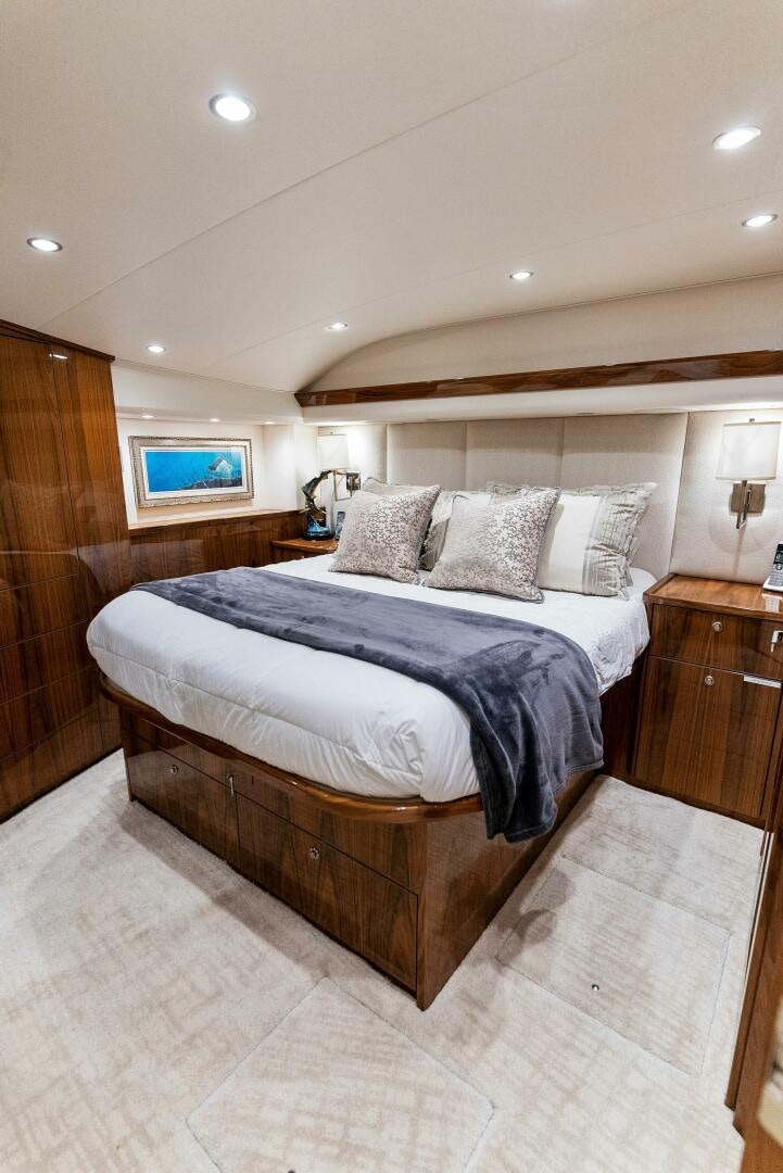 a bedroom with a bed and a wood wall aboard SEA HAWK Yacht for Sale
