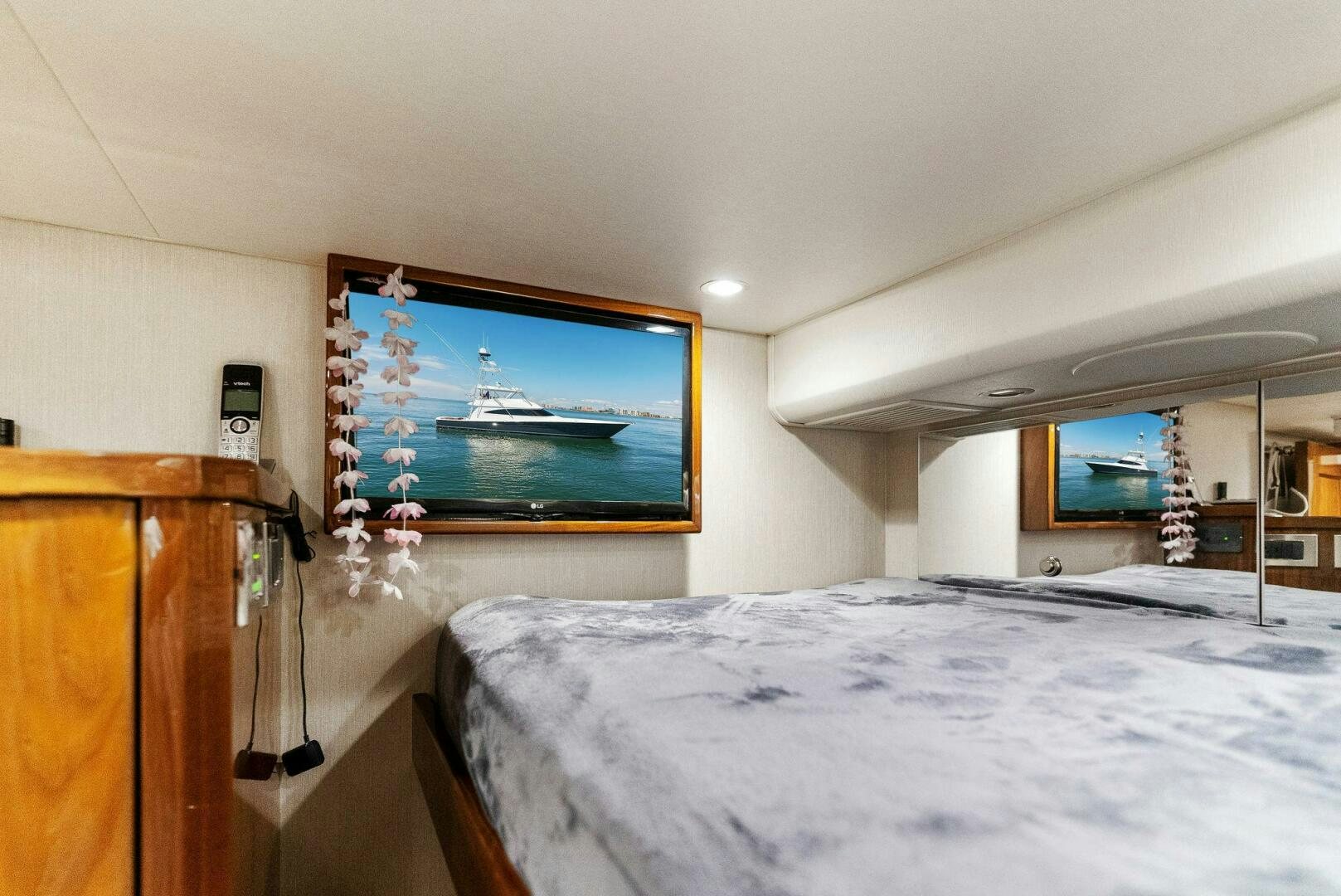 a bedroom with a large screen aboard SEA HAWK Yacht for Sale