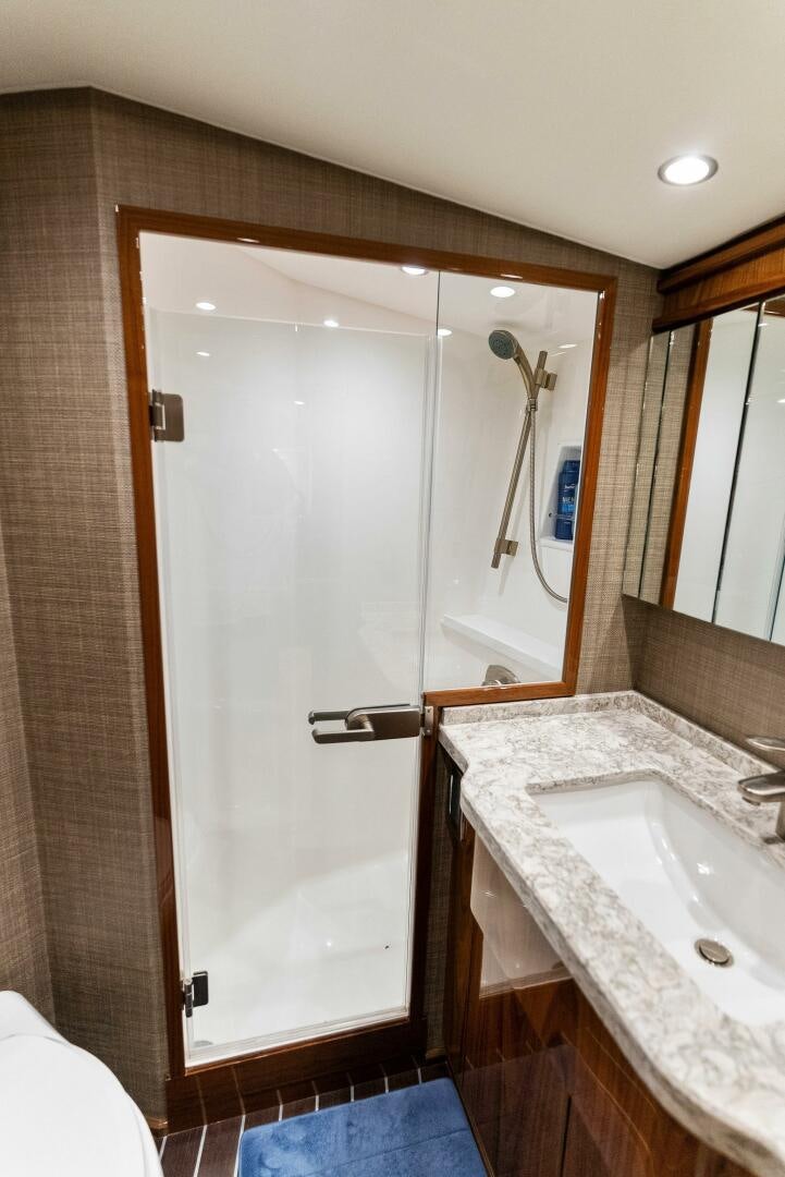 a bathroom with a sink and a shower aboard SEA HAWK Yacht for Sale