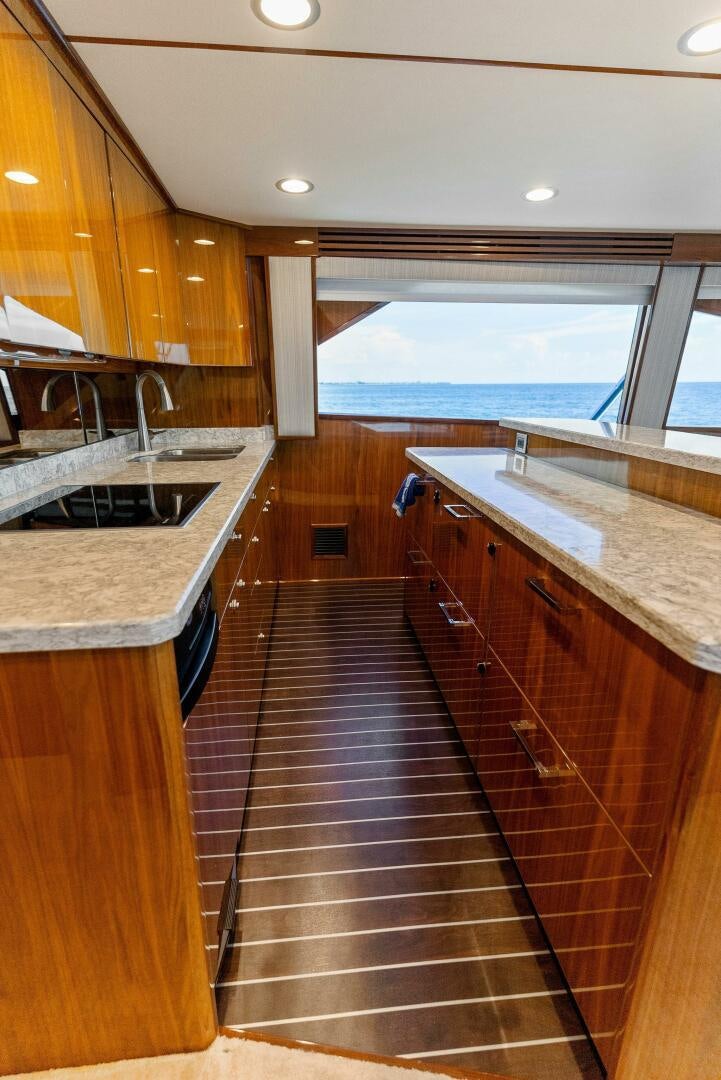 a kitchen with a large window aboard SEA HAWK Yacht for Sale