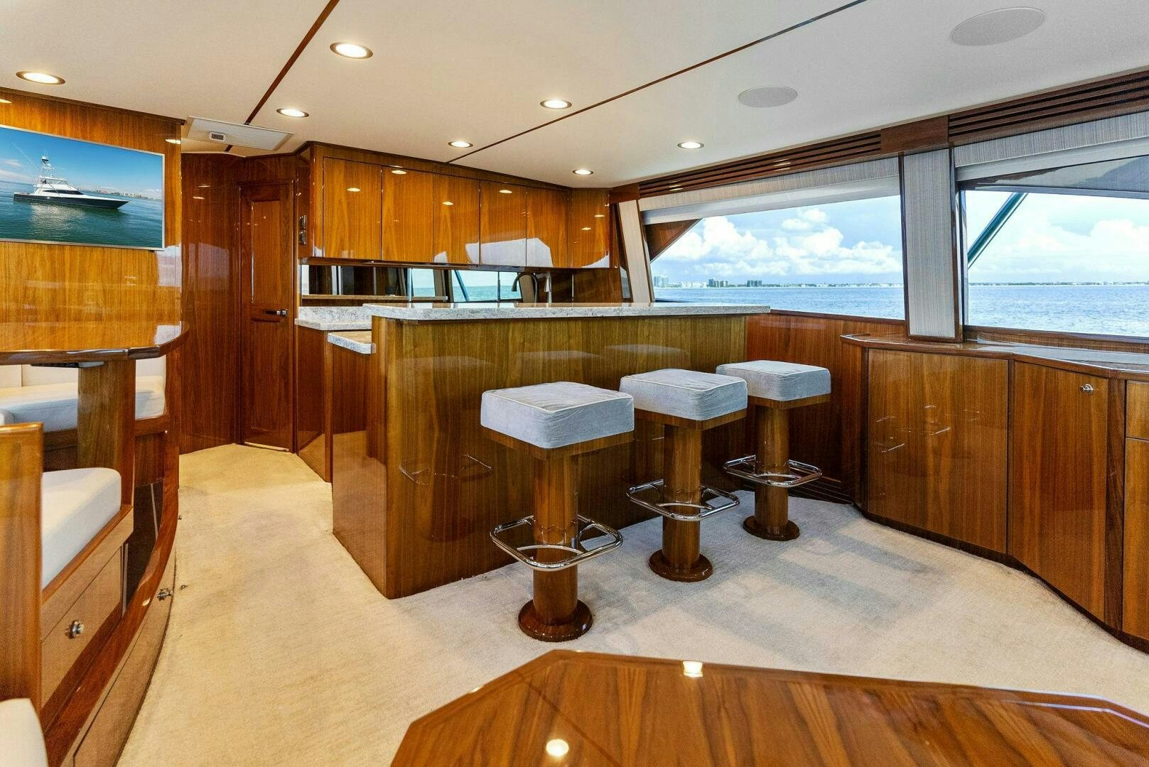 a room with wooden cabinets and a table and chairs aboard SEA HAWK Yacht for Sale