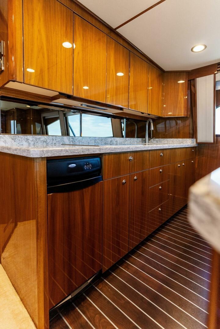 a kitchen with wooden cabinets aboard SEA HAWK Yacht for Sale