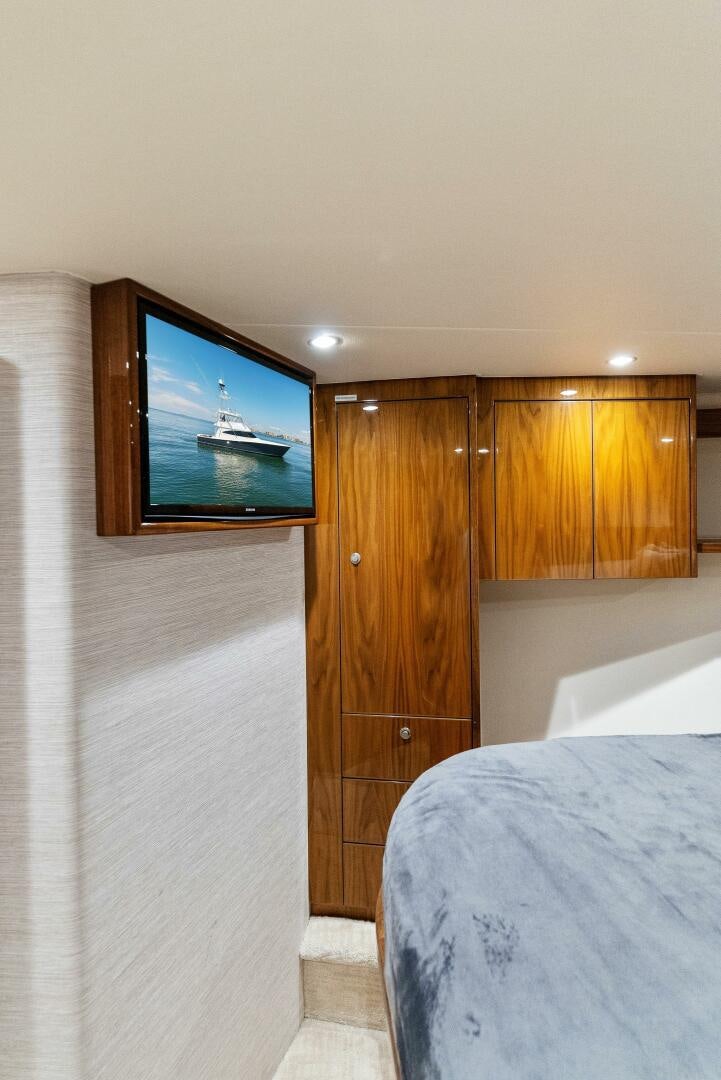 a bedroom with a television on the wall aboard SEA HAWK Yacht for Sale