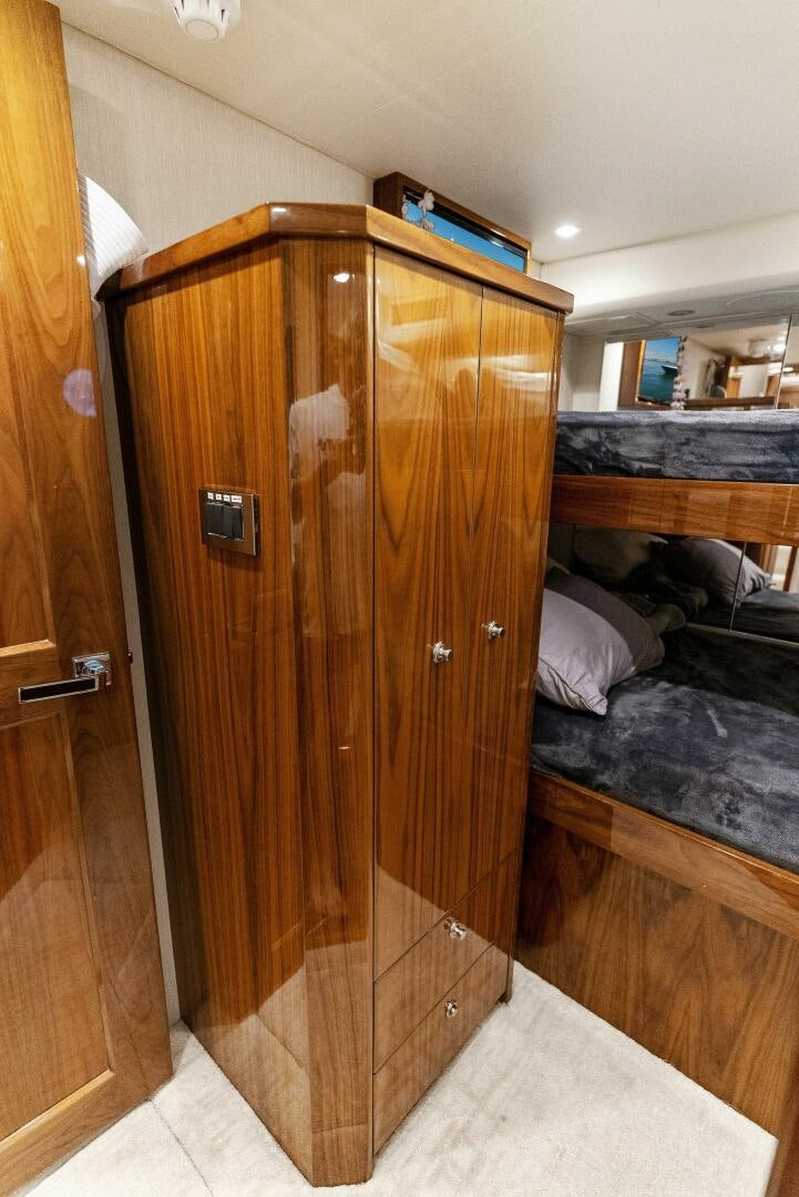 a wooden wardrobe in a bedroom aboard SEA HAWK Yacht for Sale