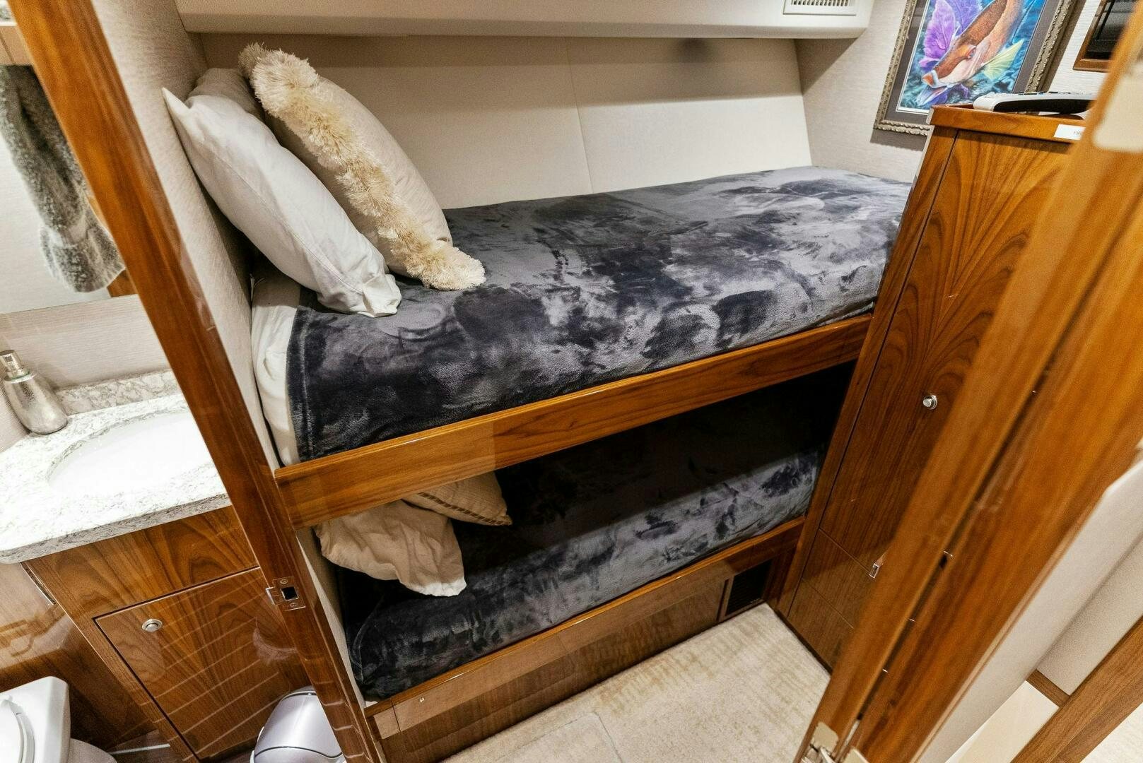 a bed with a black blanket aboard SEA HAWK Yacht for Sale