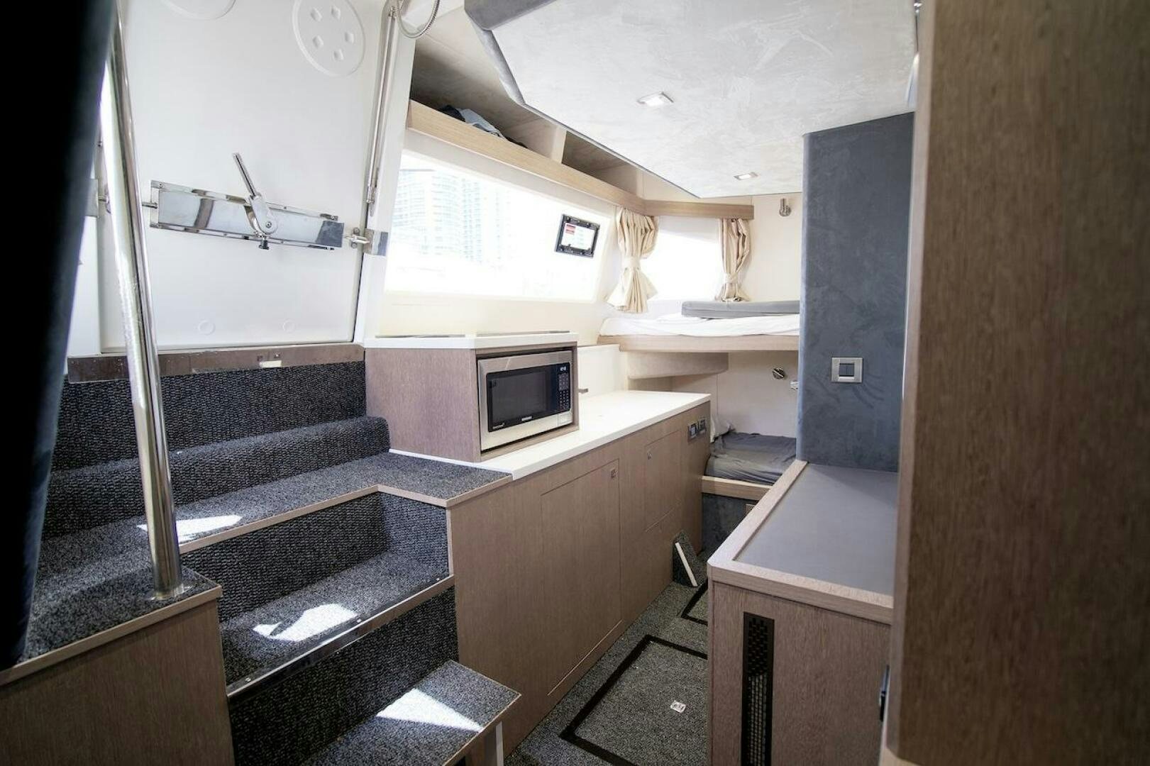 a small room with a bed and a desk aboard OUR NEXT CHAPTER Yacht for Sale