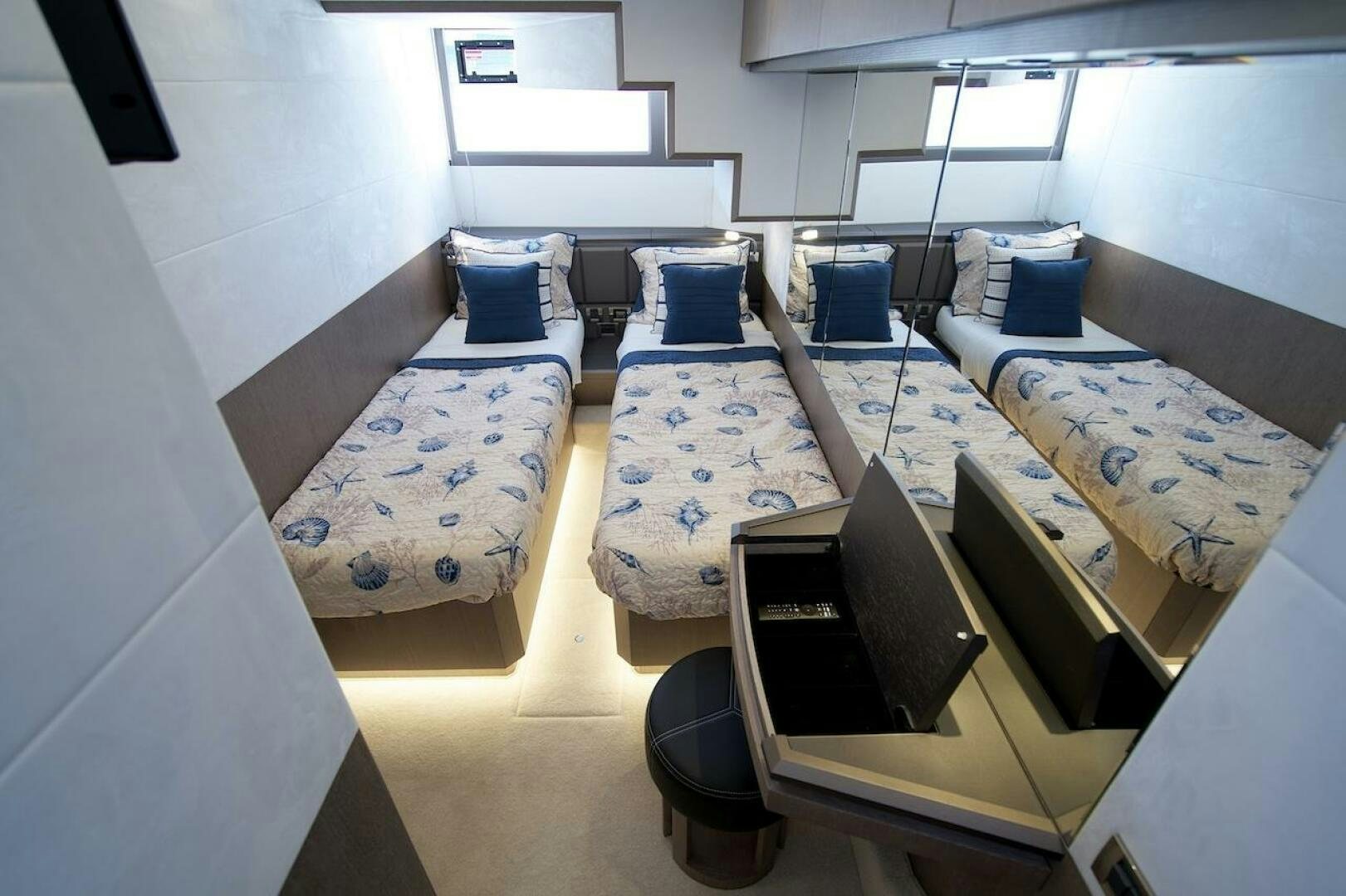 a room with beds and a large window aboard OUR NEXT CHAPTER Yacht for Sale