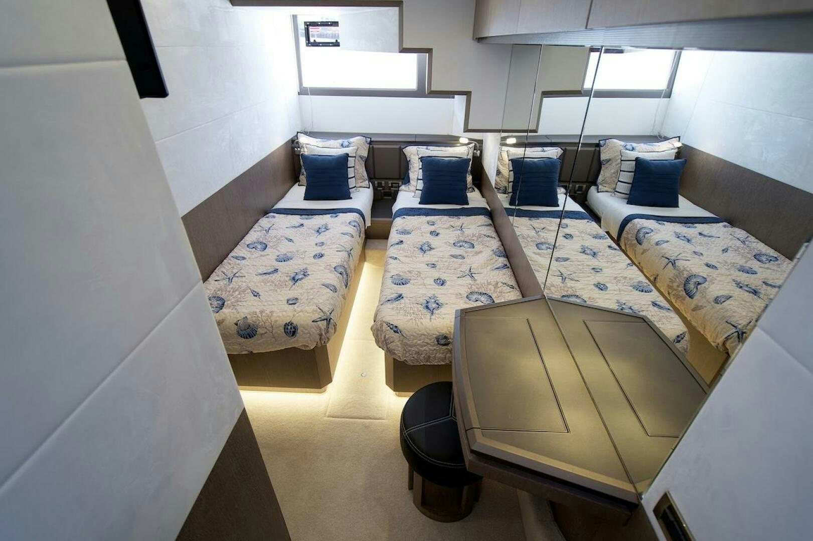 a room with beds and a chair aboard OUR NEXT CHAPTER Yacht for Sale