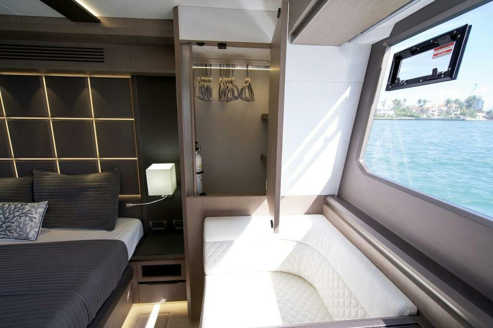 a room with a bed and a window aboard OUR NEXT CHAPTER Yacht for Sale
