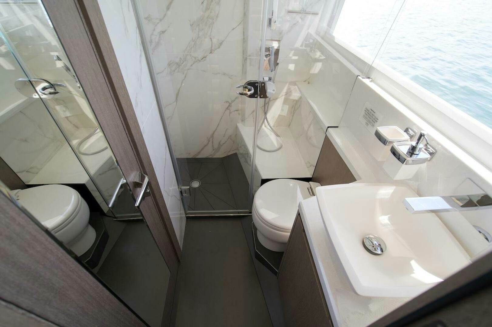 a bathroom with a sink toilet and bathtub aboard OUR NEXT CHAPTER Yacht for Sale
