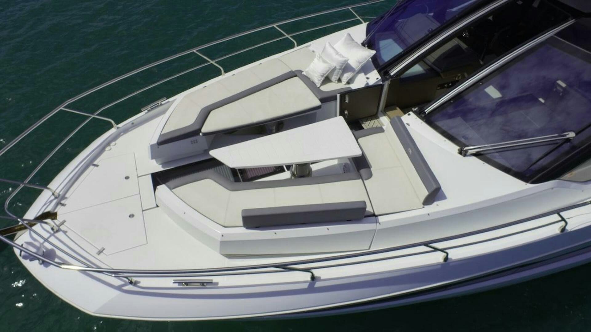 a white boat with a blue stripe aboard OUR NEXT CHAPTER Yacht for Sale