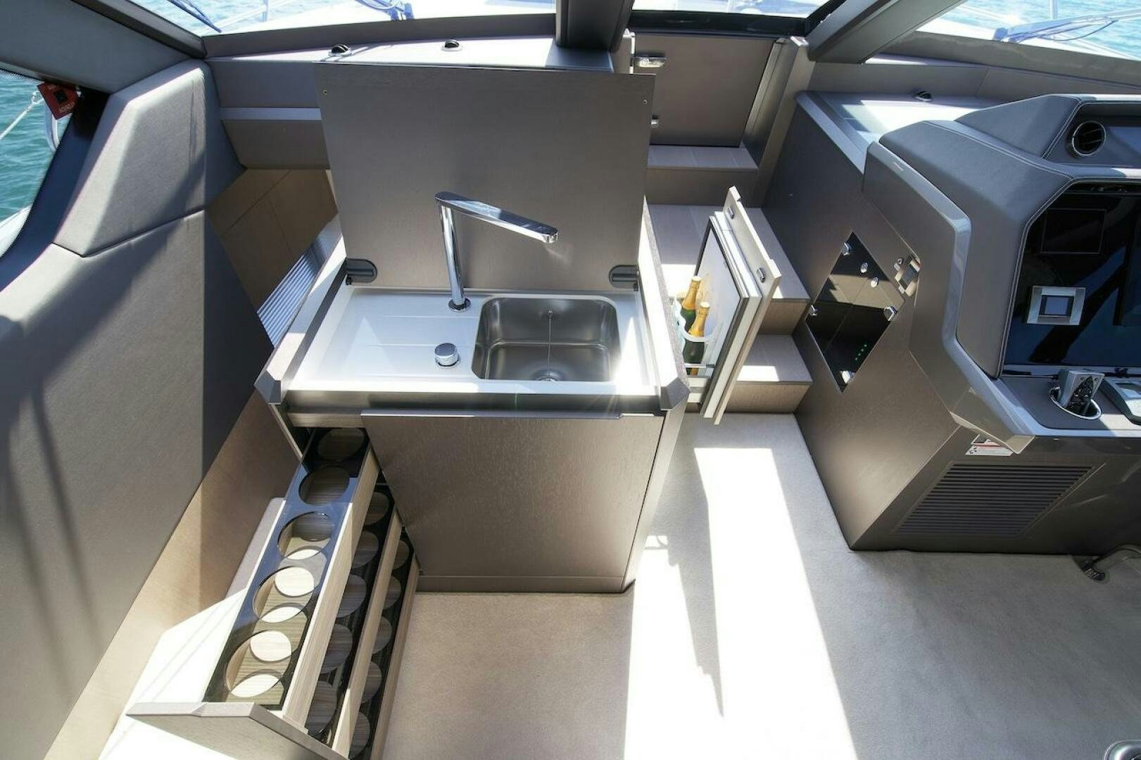 a car with a large open door aboard OUR NEXT CHAPTER Yacht for Sale