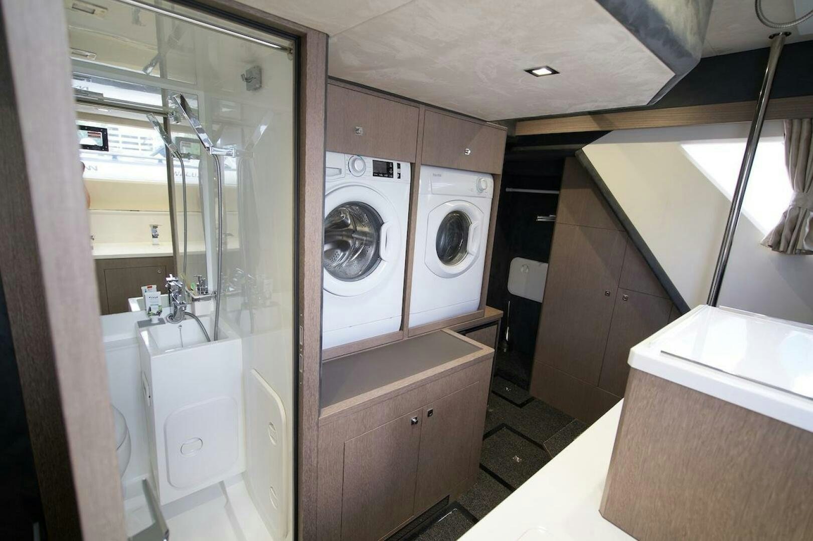 a bathroom with a washing machine aboard OUR NEXT CHAPTER Yacht for Sale