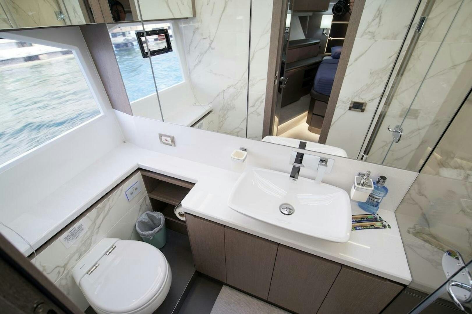 a bathroom with a sink and a toilet aboard OUR NEXT CHAPTER Yacht for Sale