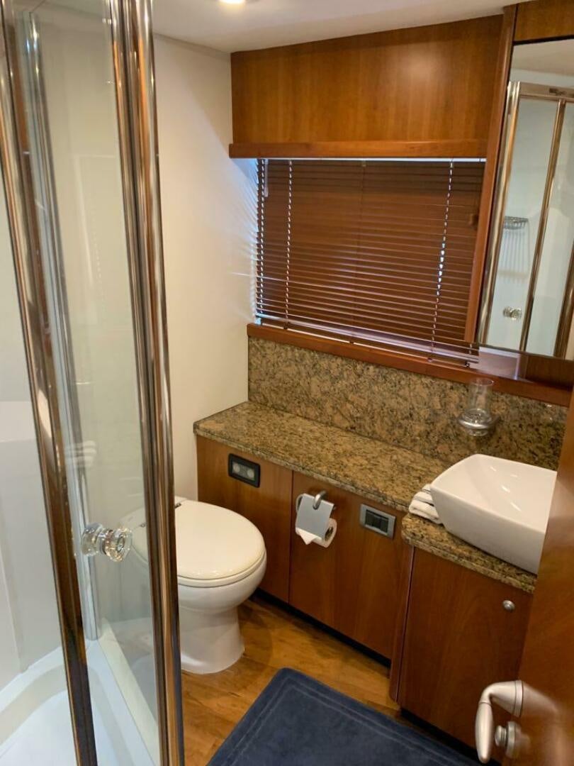 a bathroom with a sink toilet and a mirror aboard JULCAN II Yacht for Sale