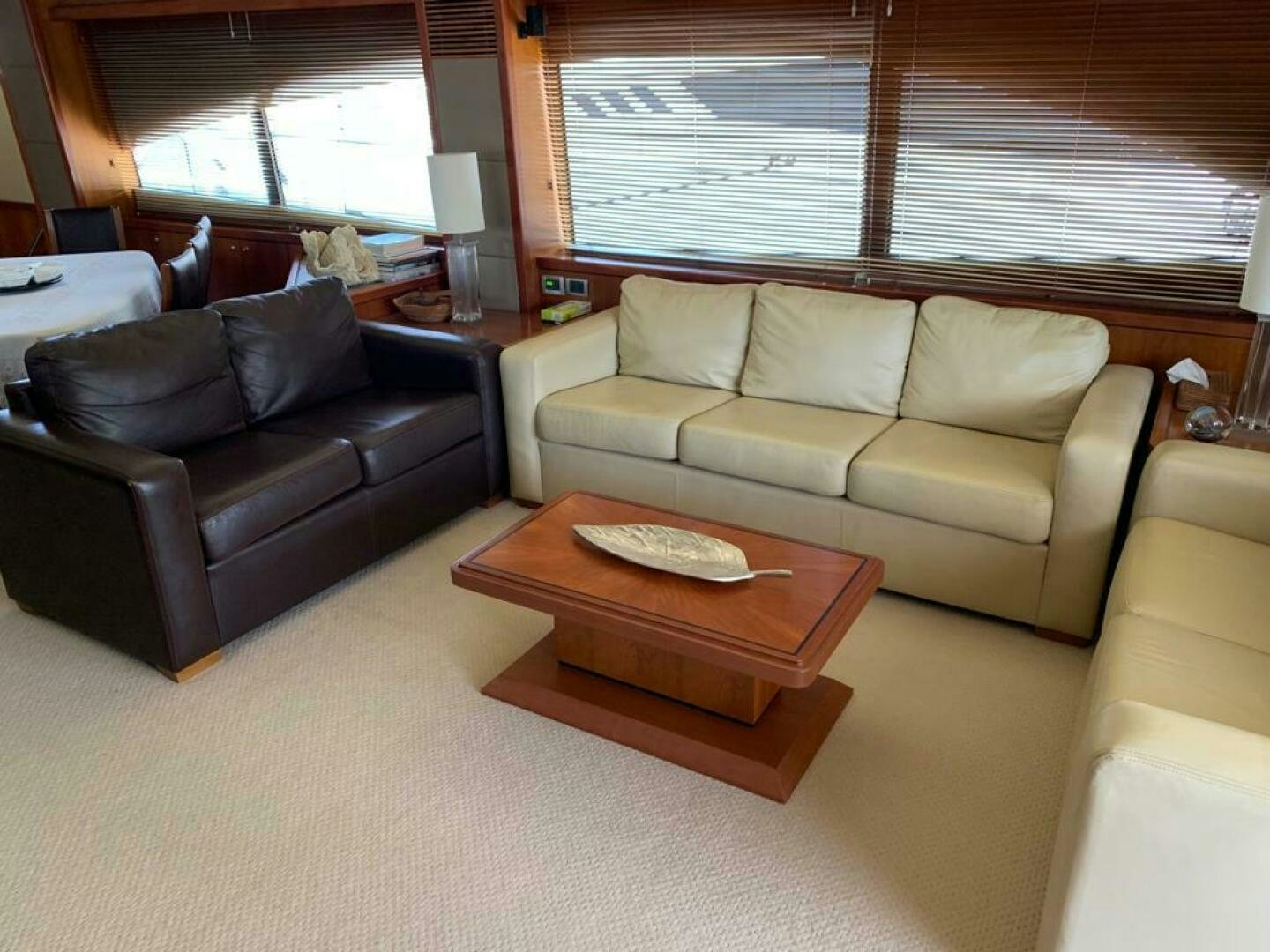 a living room with a couch and a coffee table aboard JULCAN II Yacht for Sale