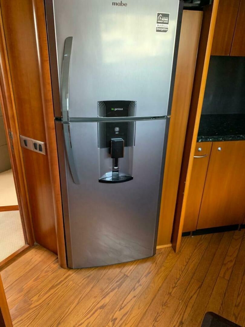 a refrigerator in a kitchen aboard JULCAN II Yacht for Sale