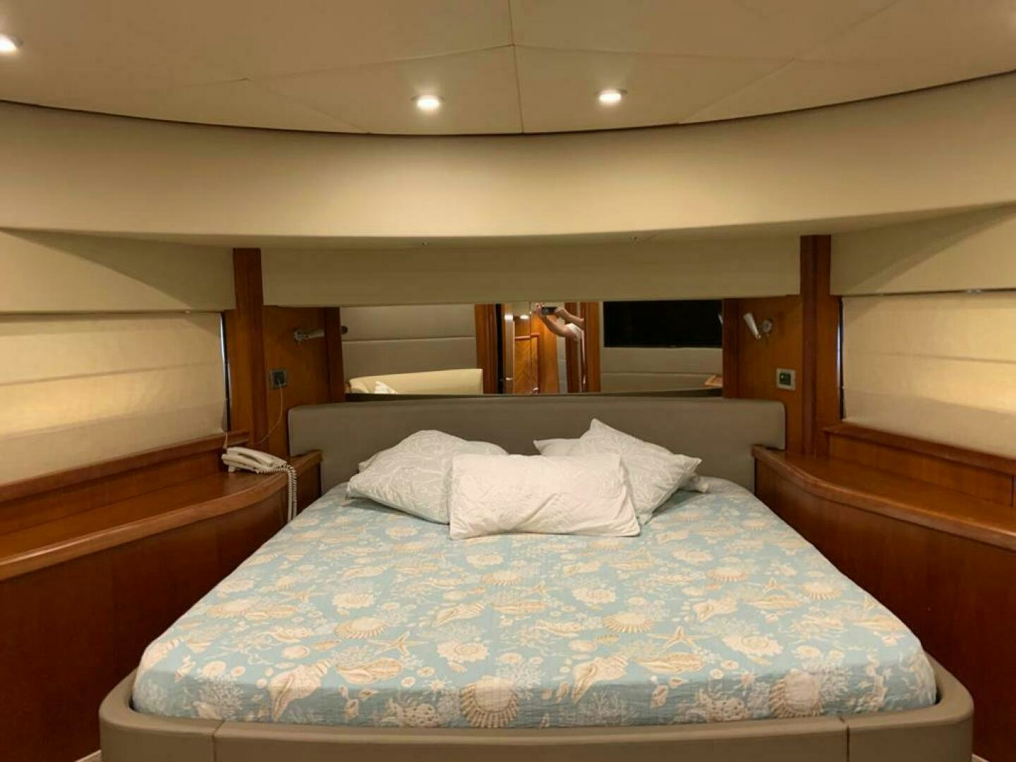 a bed with a blue comforter aboard JULCAN II Yacht for Sale