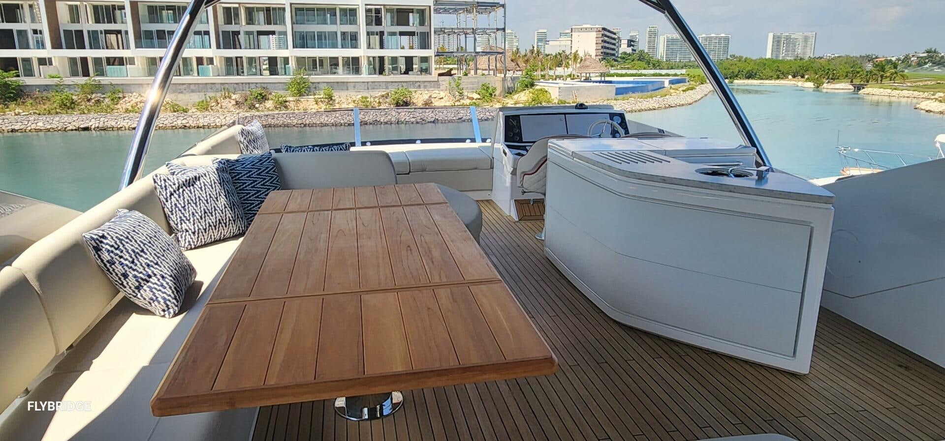 a deck with a table and chairs on it aboard 5 MARES Yacht for Sale