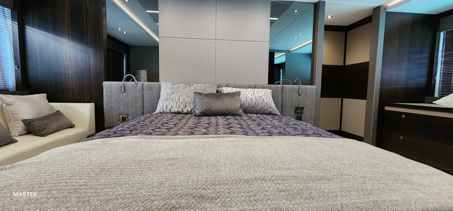 a bed with a white comforter aboard 5 MARES Yacht for Sale