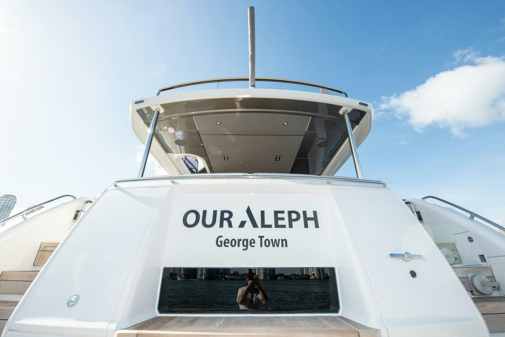 a person standing in front of a white vehicle with a large round dome on top aboard OUR ALEPH Yacht for Sale