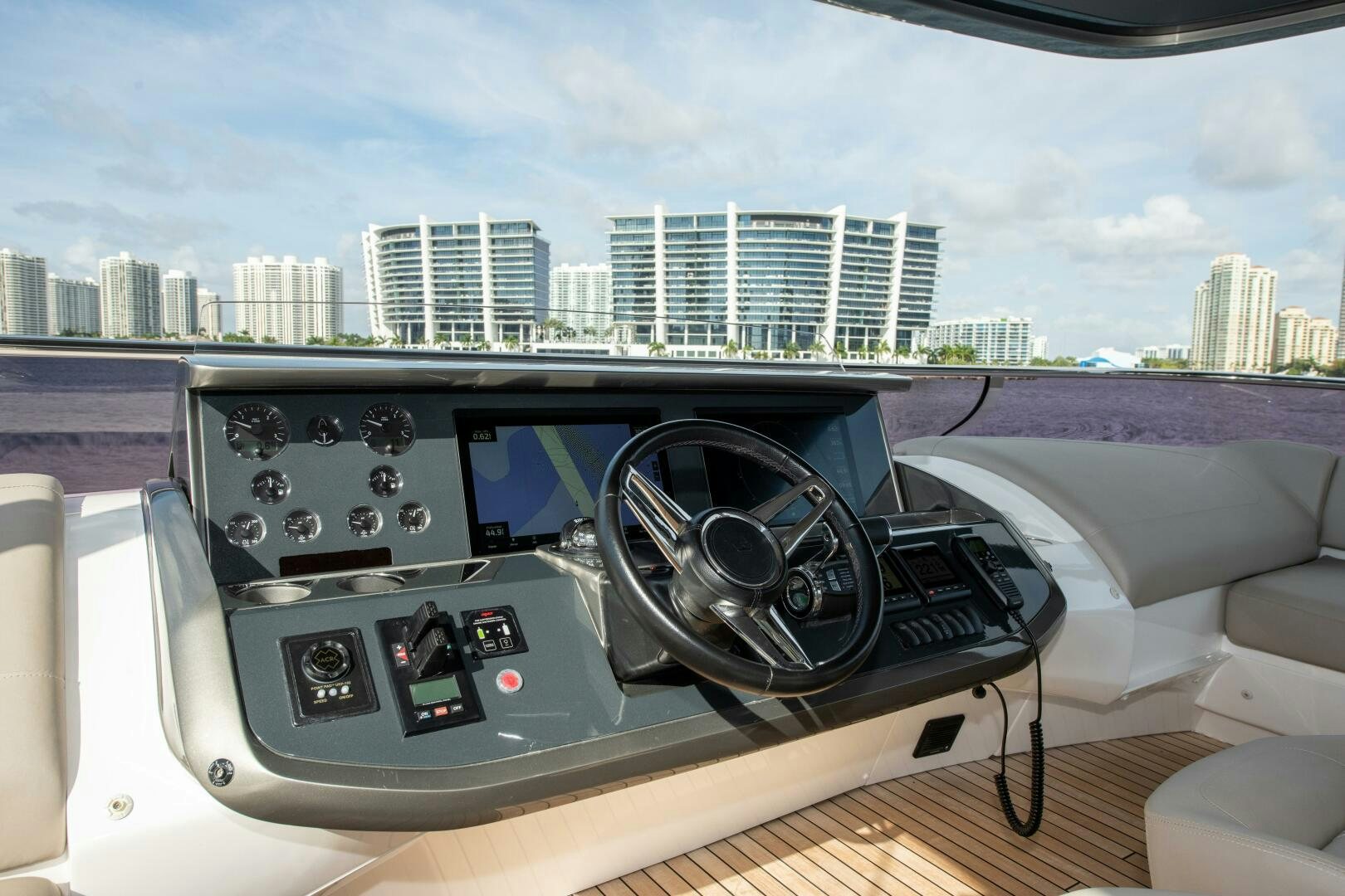 a car dashboard with a city in the background aboard OUR ALEPH Yacht for Sale