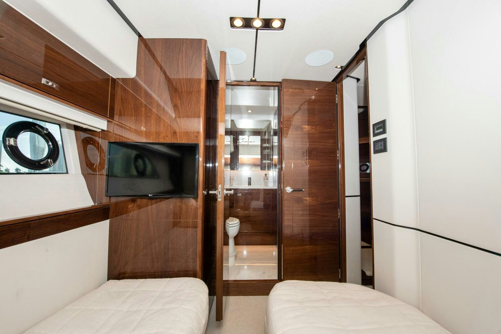 a room with a bed and a television aboard OUR ALEPH Yacht for Sale