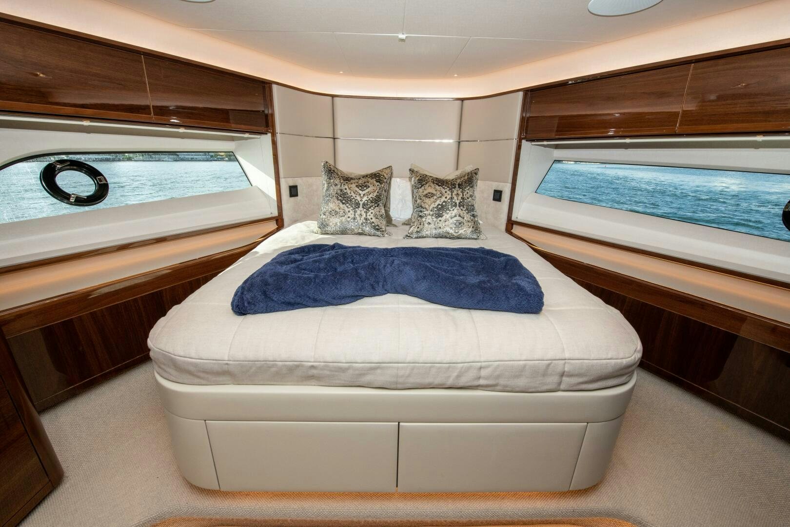 a cat lying on a bed aboard OUR ALEPH Yacht for Sale