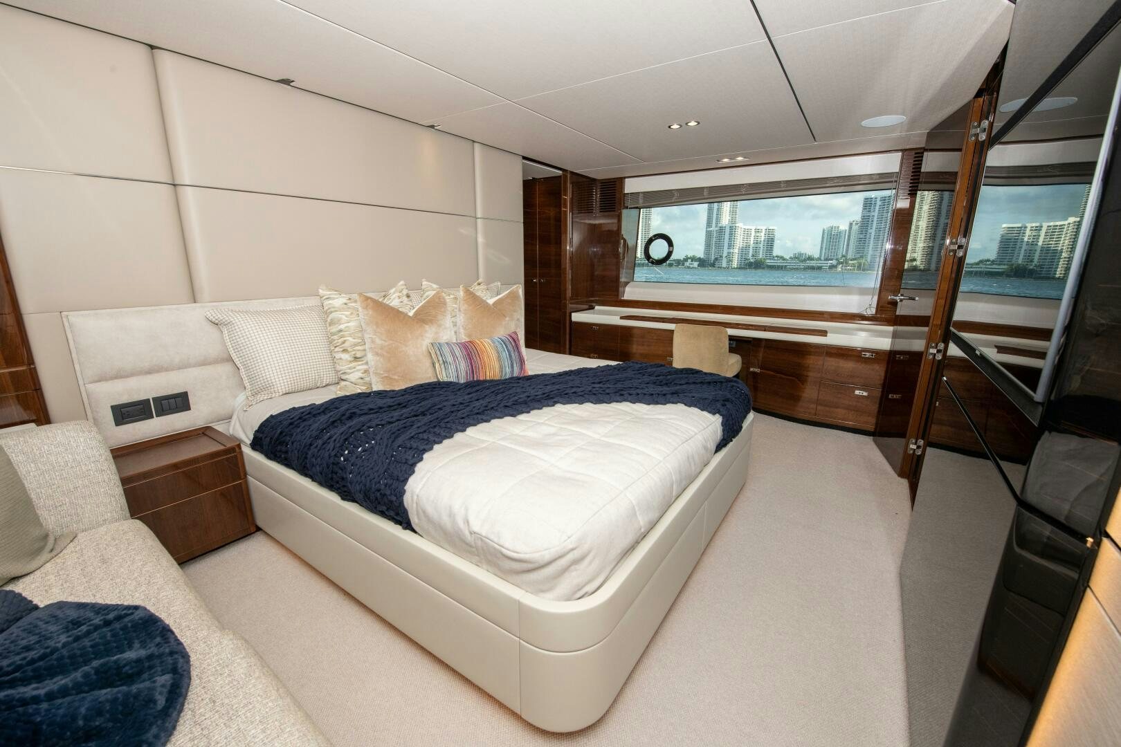 a bedroom with a bed and a window aboard OUR ALEPH Yacht for Sale