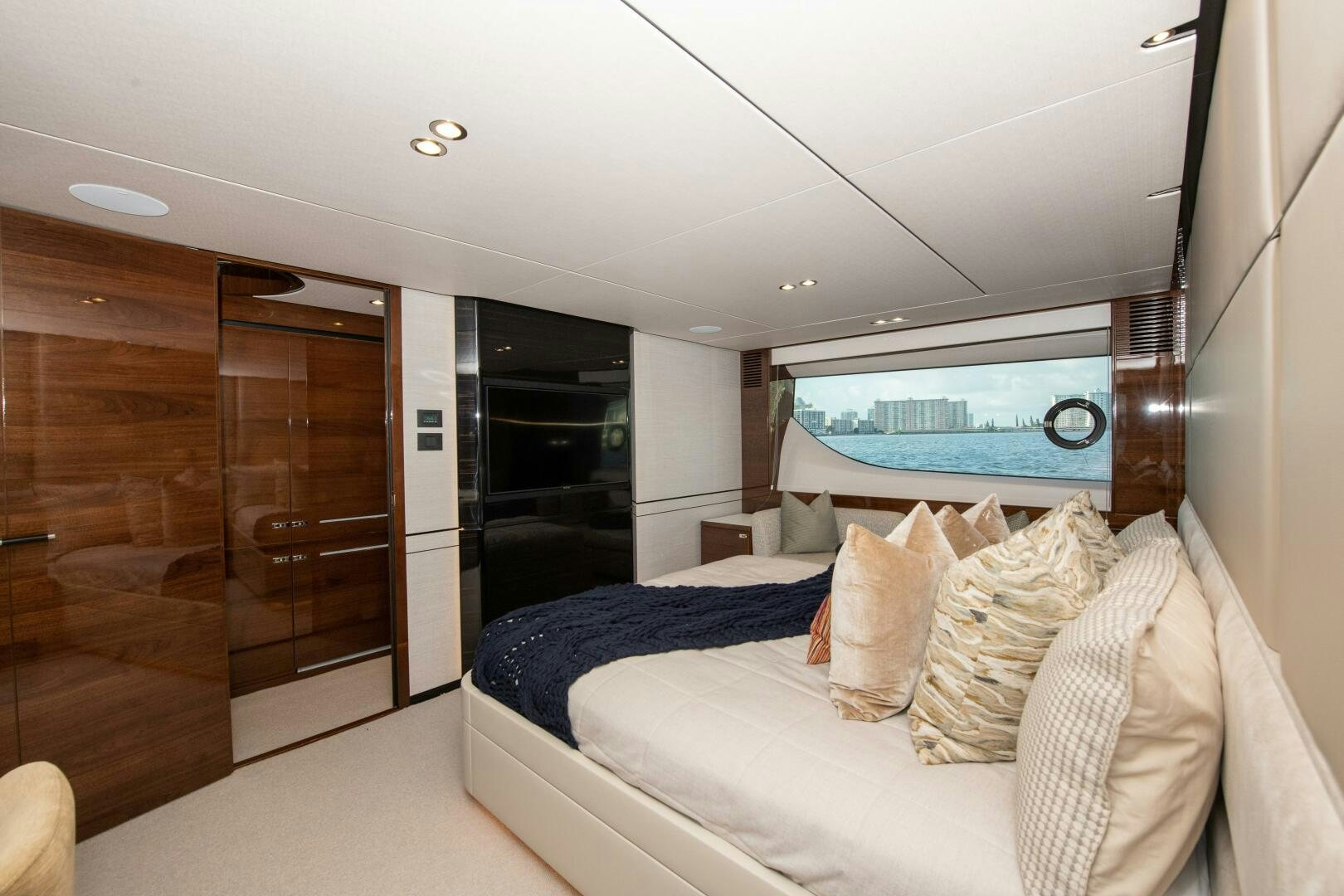a bedroom with a bed and a sliding glass door aboard OUR ALEPH Yacht for Sale