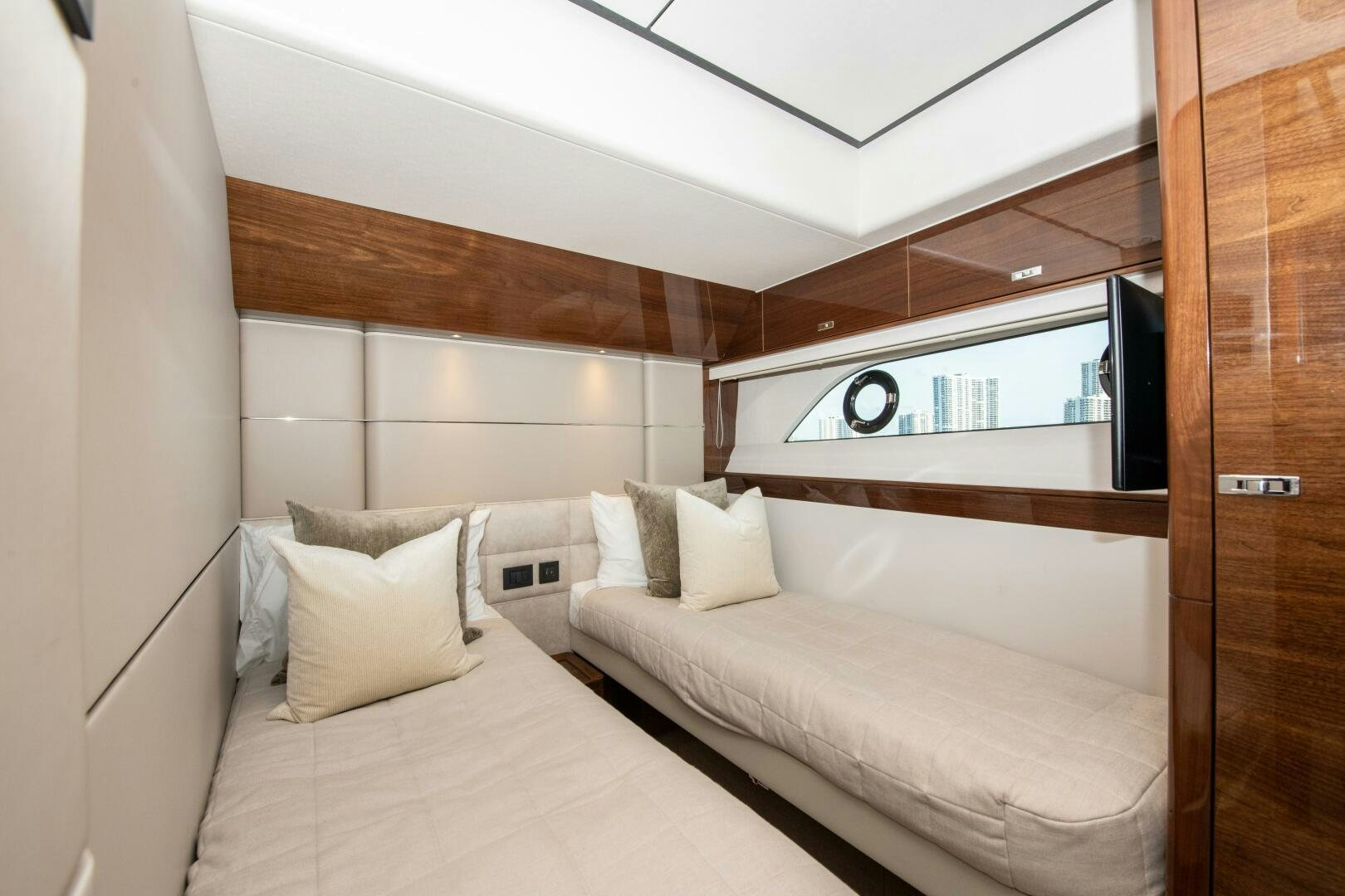 a room with a bed and a television aboard OUR ALEPH Yacht for Sale