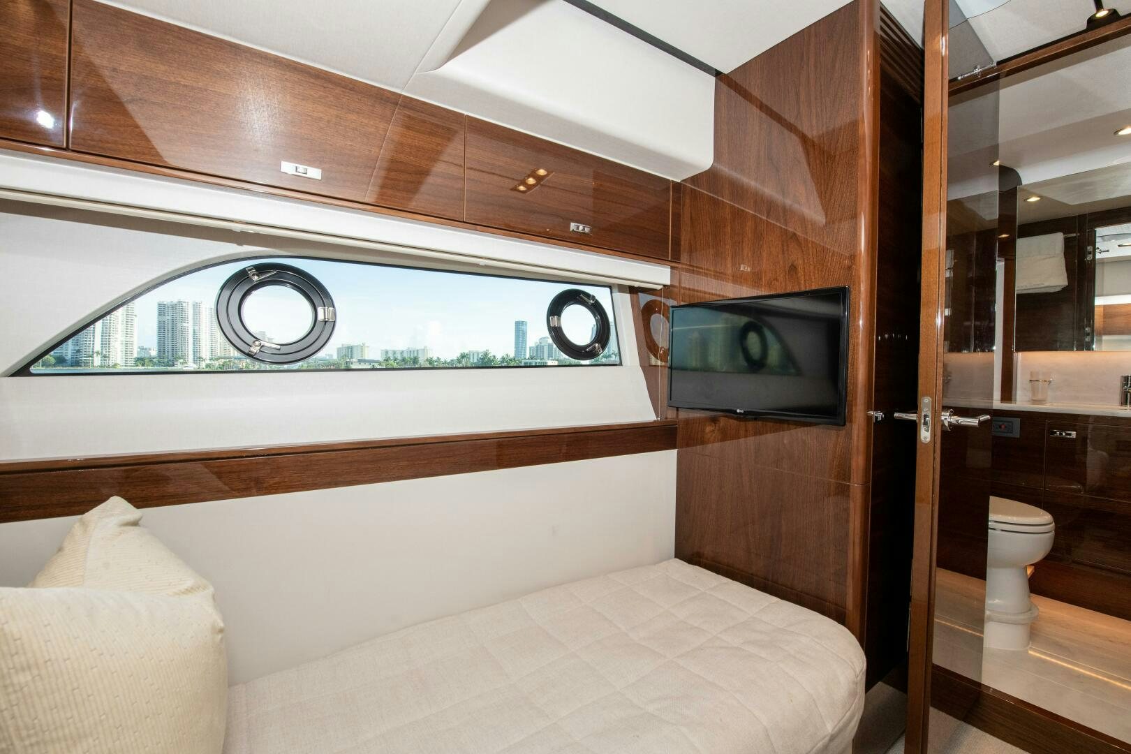 a room with a bed and a television aboard OUR ALEPH Yacht for Sale