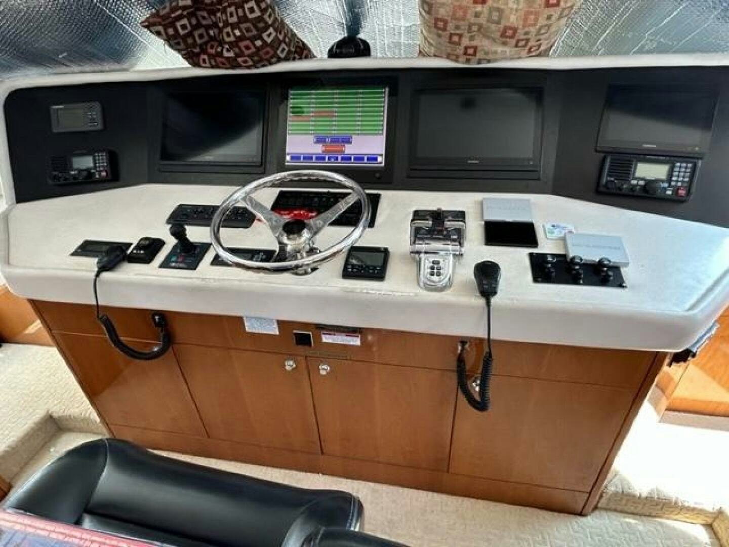 a computer desk with a fan and electronics on it aboard LIVNWEL Yacht for Sale