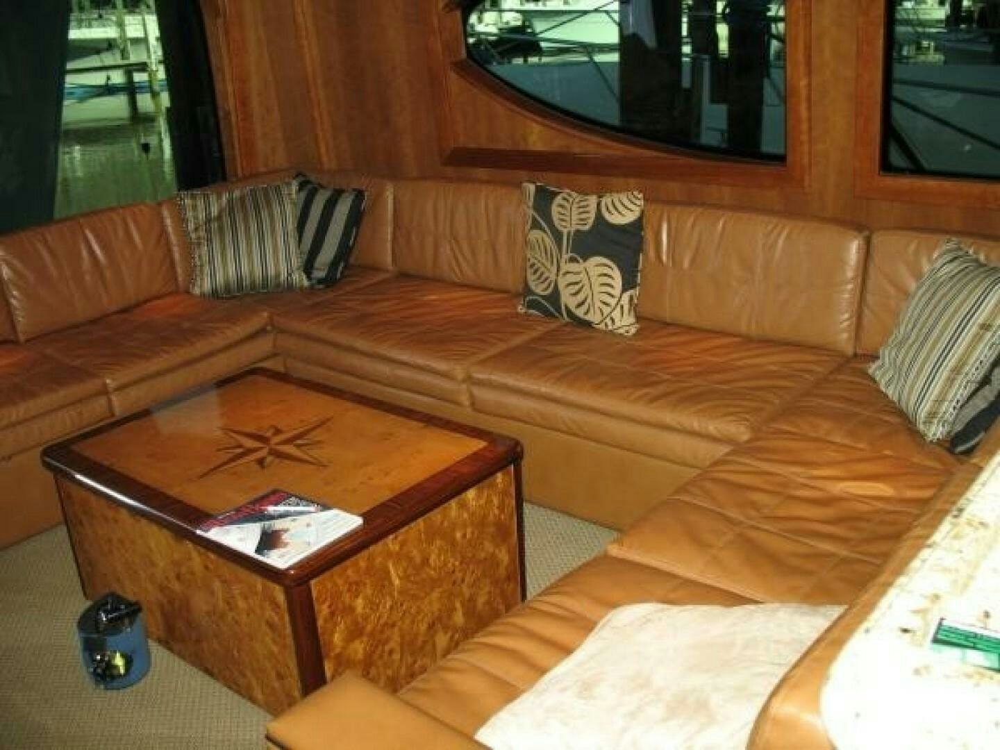 a living room with a brown couch aboard LIVNWEL Yacht for Sale