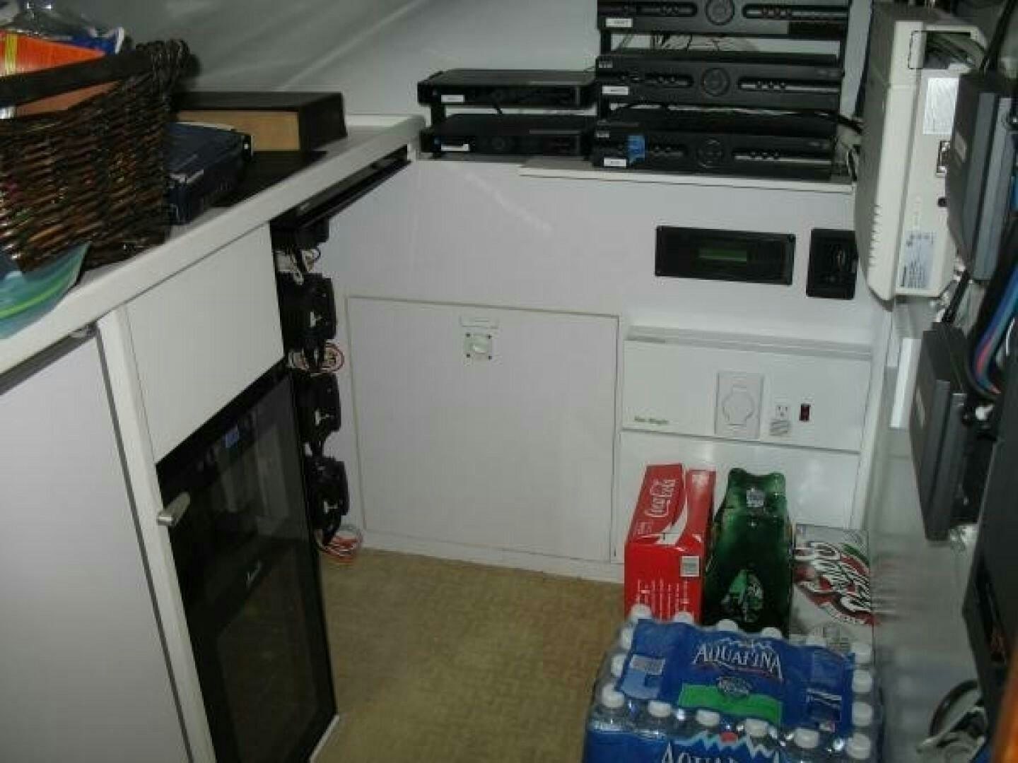 a white cabinet with a black box and a black box on it aboard LIVNWEL Yacht for Sale