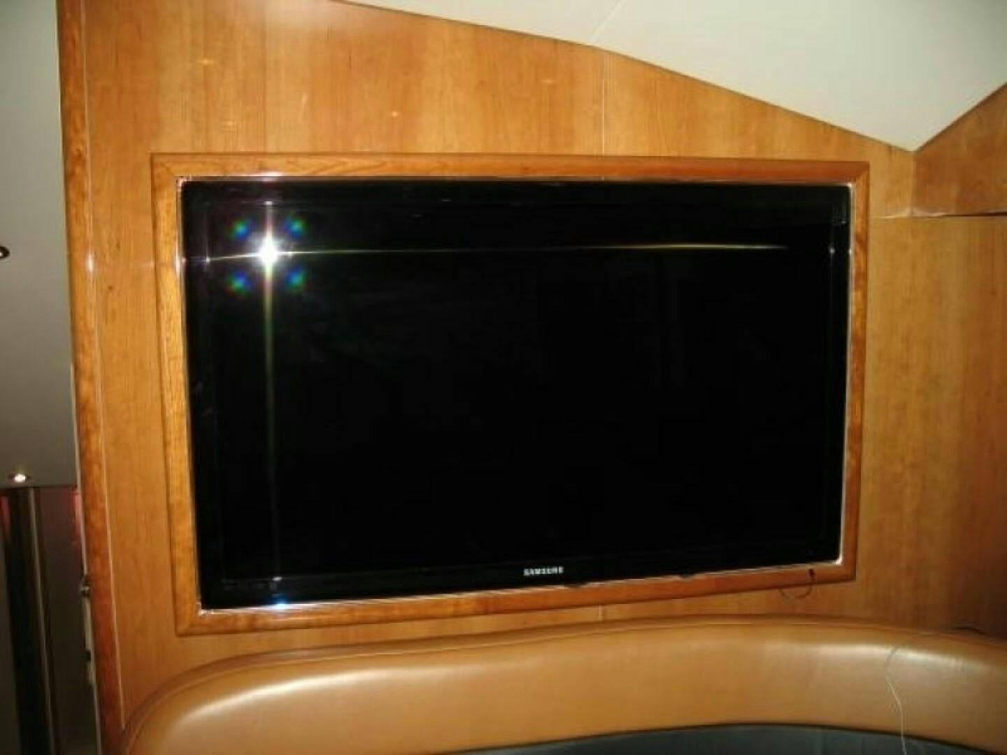 a black television on a wooden wall aboard LIVNWEL Yacht for Sale