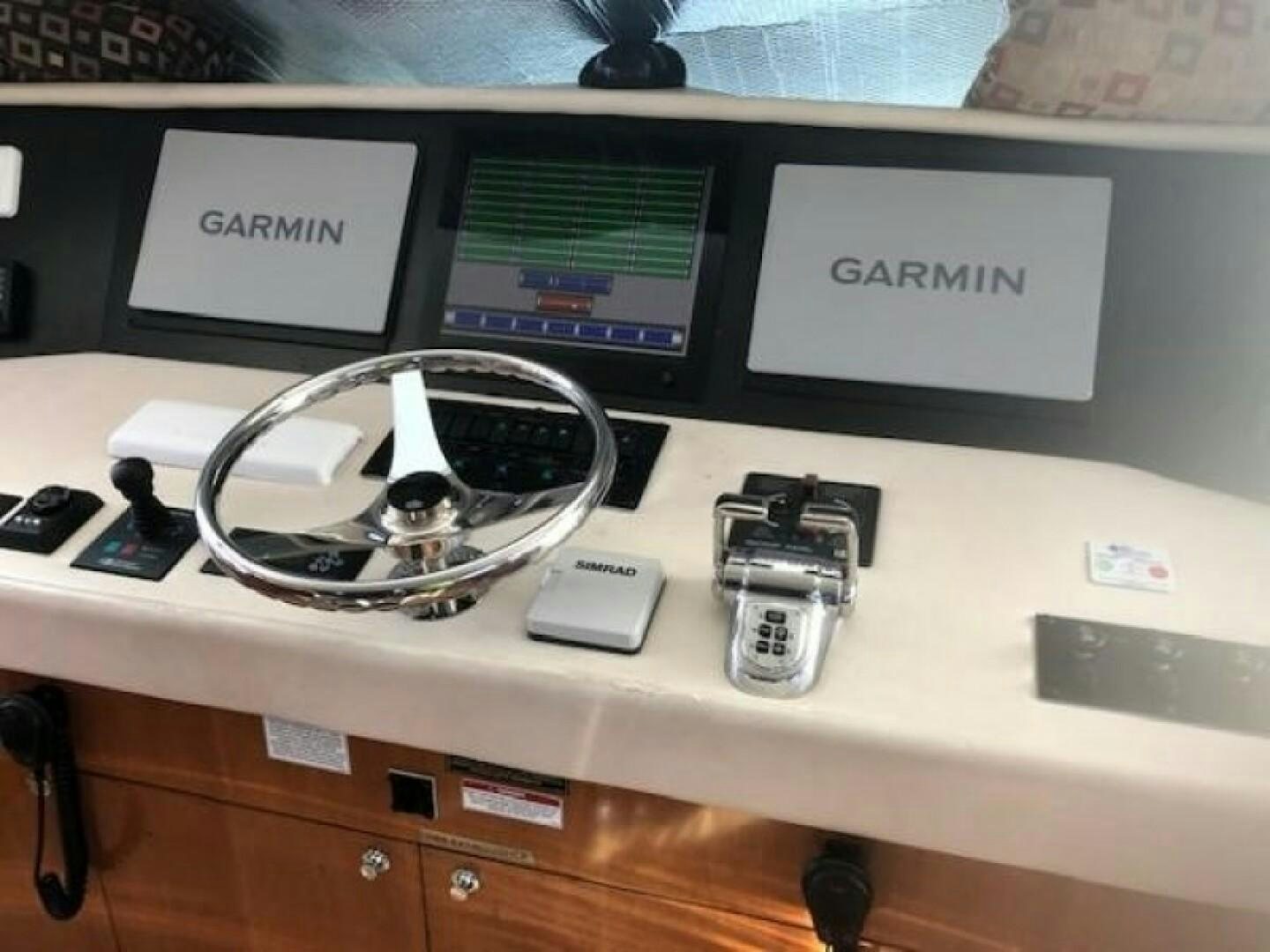 a white computer with a white headphone and a black and white headphone on a desk with aboard LIVNWEL Yacht for Sale