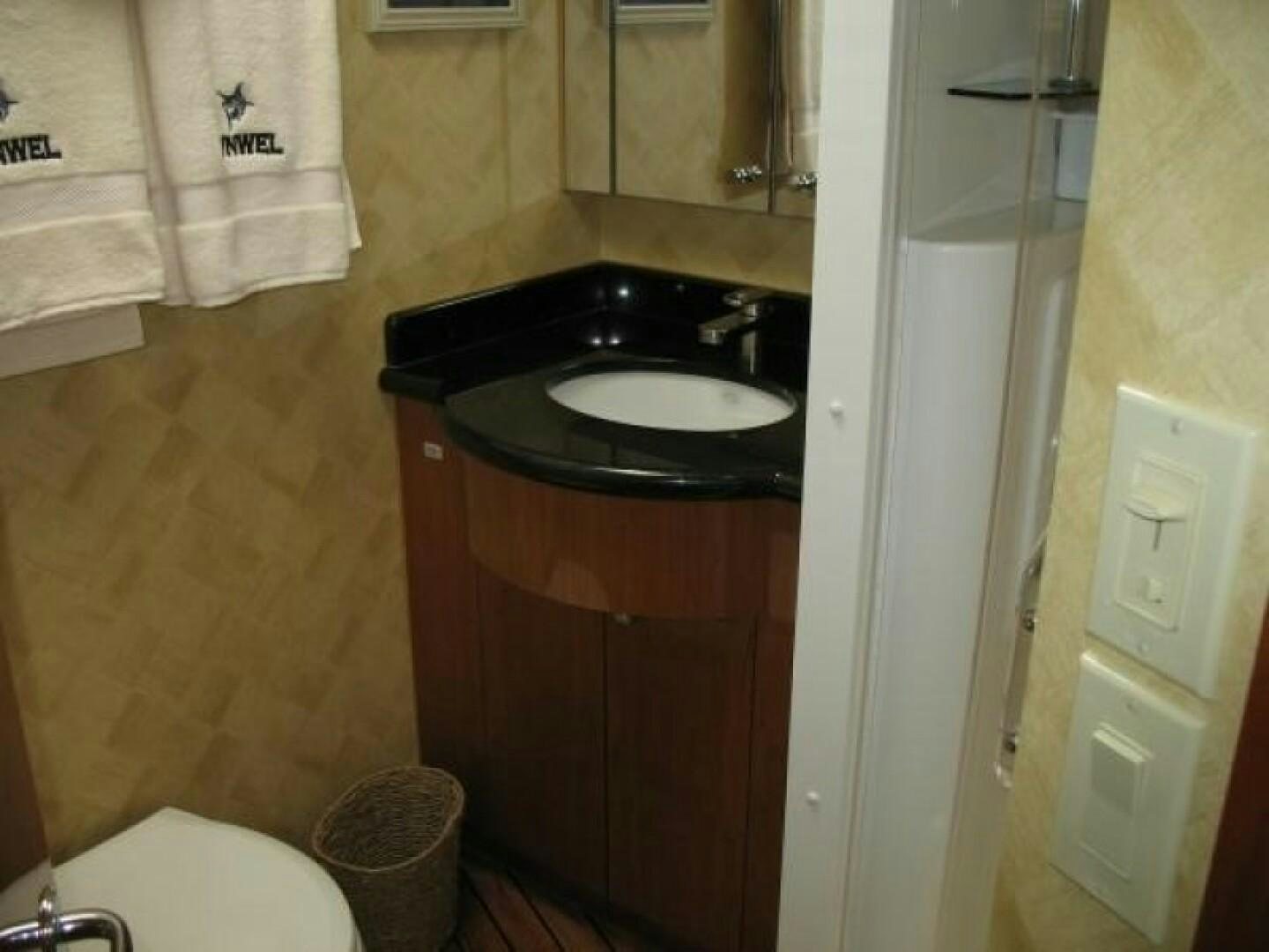 a sink and a mirror in a bathroom aboard LIVNWEL Yacht for Sale