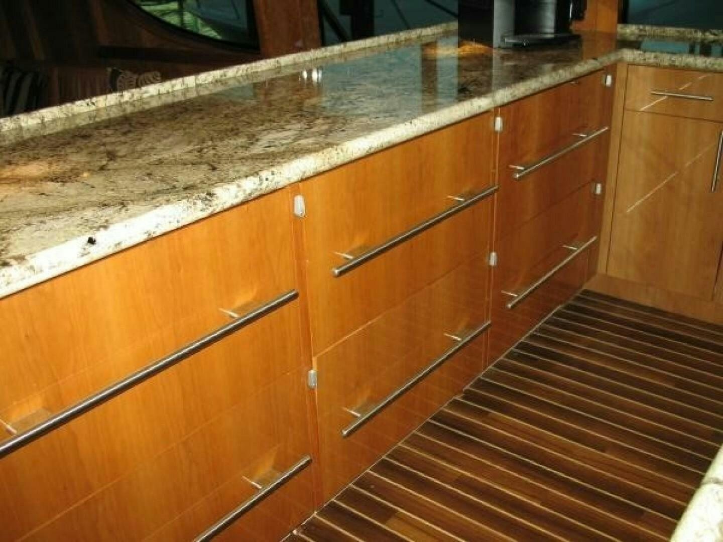 a kitchen counter with wooden cabinets aboard LIVNWEL Yacht for Sale